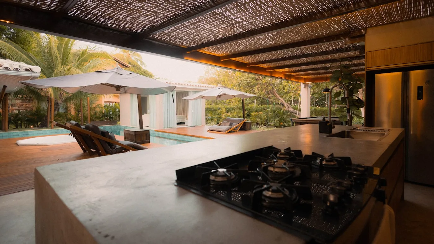 Outdoor kitchen with stone countertop by the pool