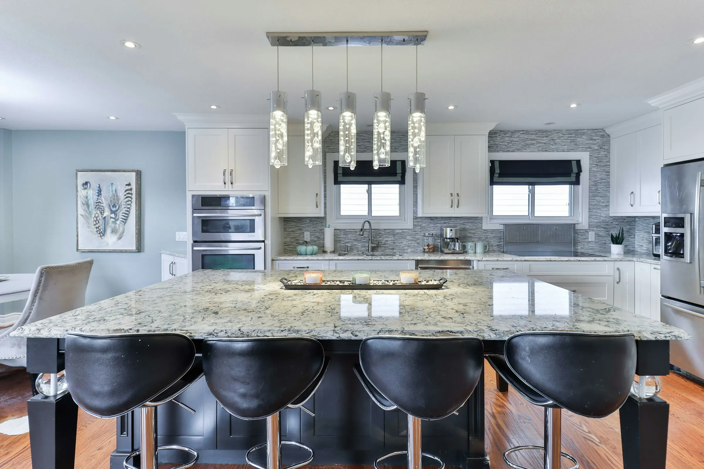 Kitchen with a large granite island and pendant lighting