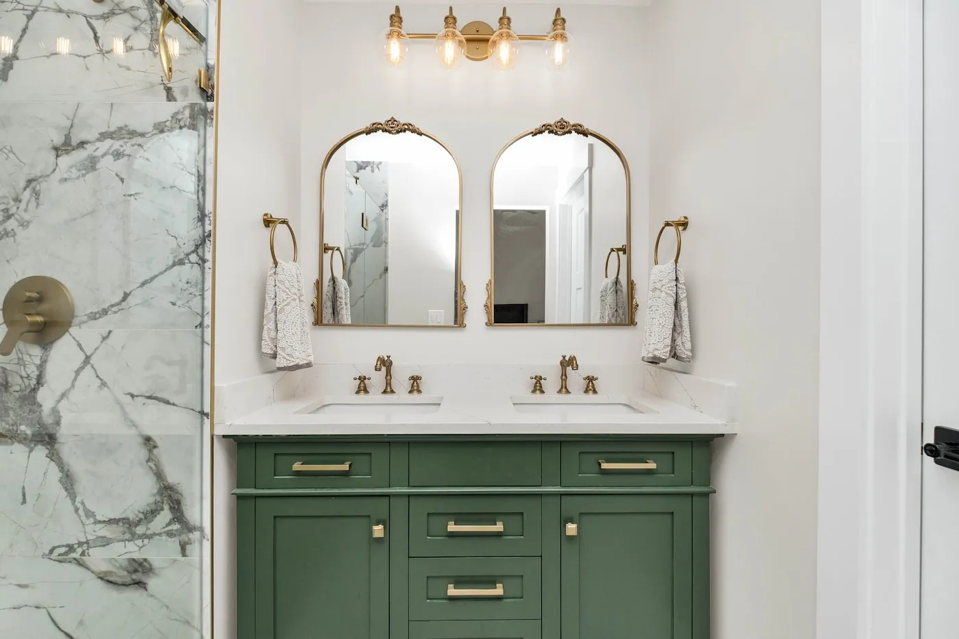 Bathroom with marble walls and green double vanity